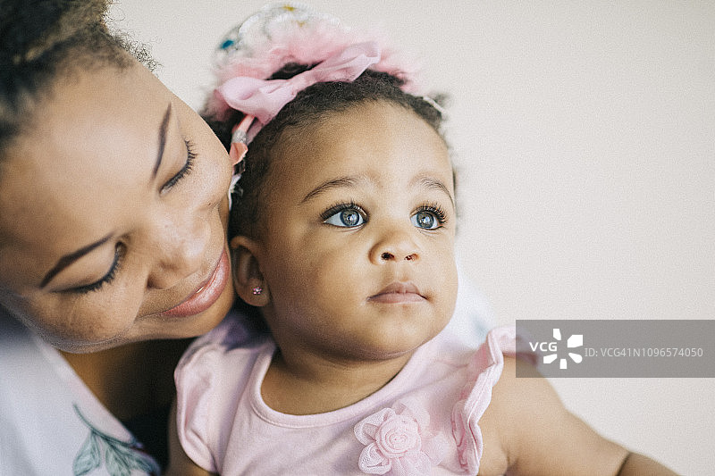 慈爱的母亲和她一岁的女婴一起玩耍图片素材