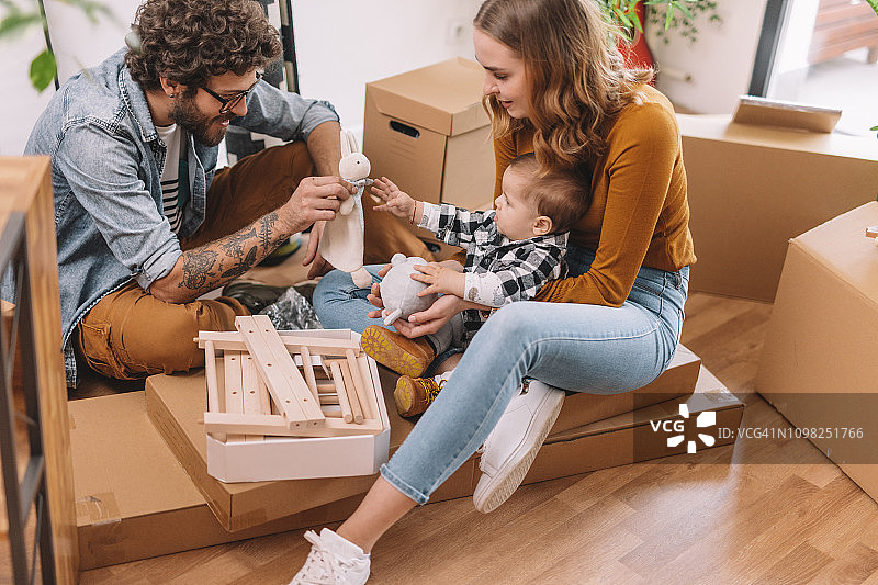 妈妈、爸爸和小儿子一起组装新家家具图片素材