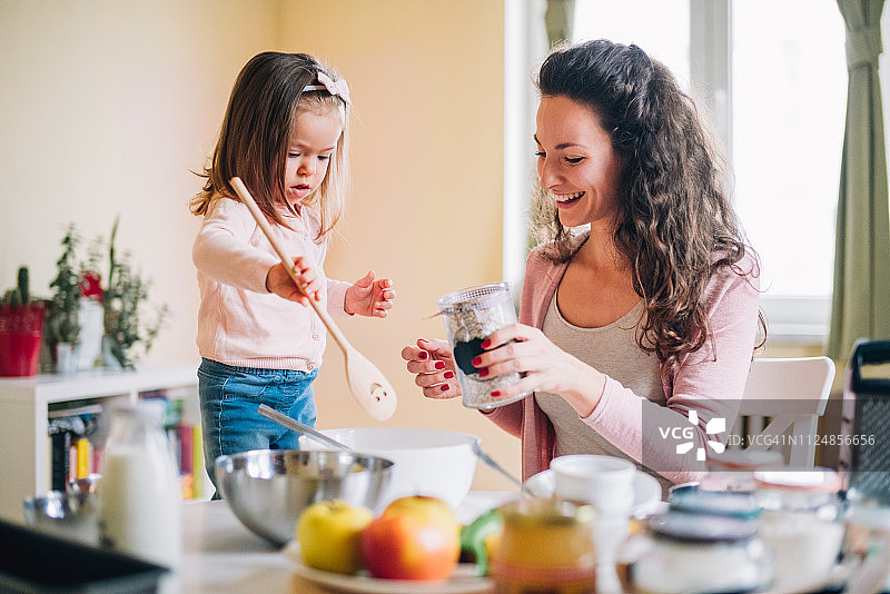 快乐的母女在厨房里图片素材