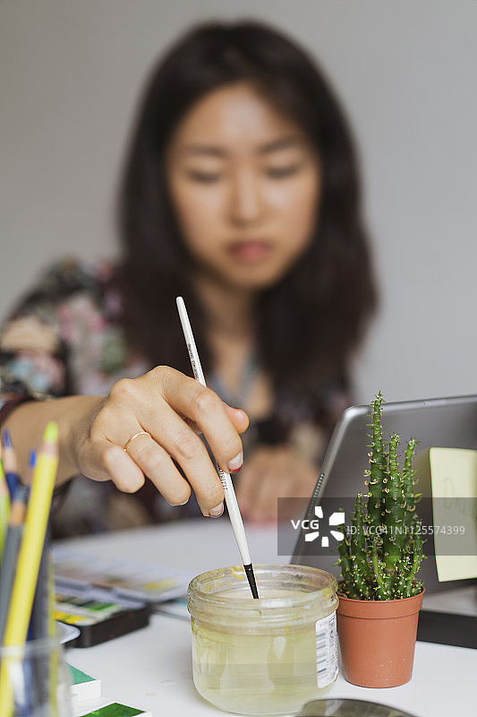 工作室工作台上绘画的插画师，特写图片素材