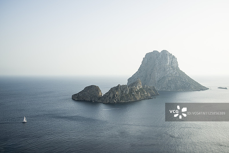 在西班牙伊维萨岛日落时分环绕埃斯维德拉岛航行的船只图片素材