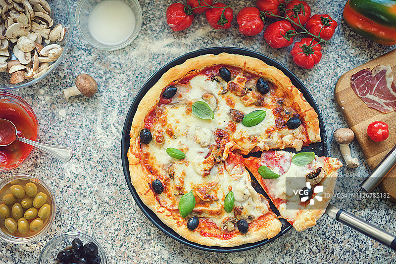 新鲜出炉的自制披萨与配料图片素材