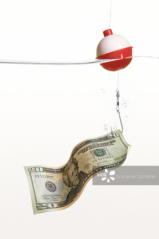 鱼线、浮标和鱼钩上的20美元钞票特写图片素材