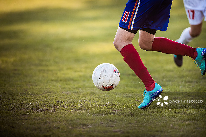 足球运动员在比赛中带球奔跑图片素材