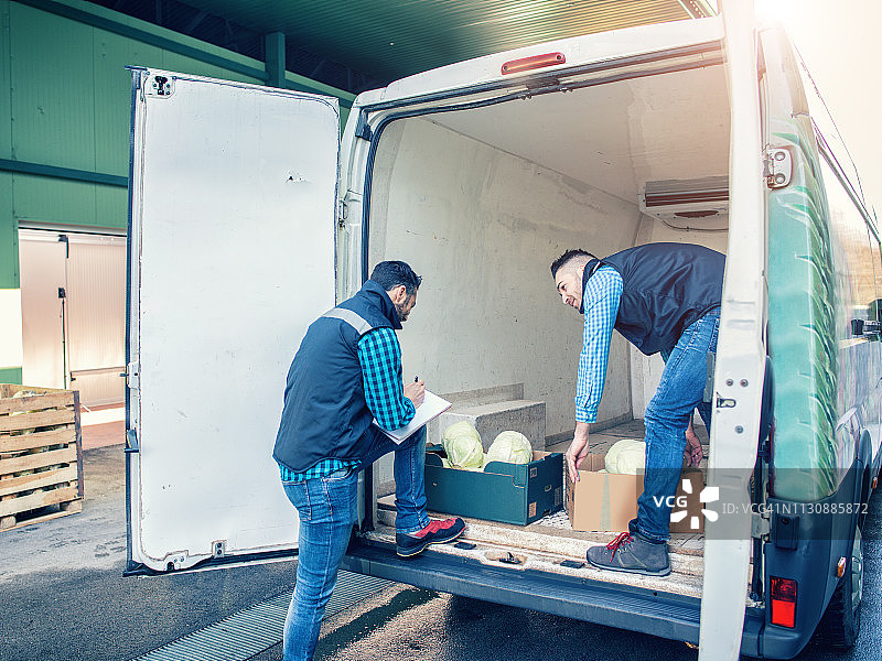 男人们正在搬运蔬菜箱图片素材