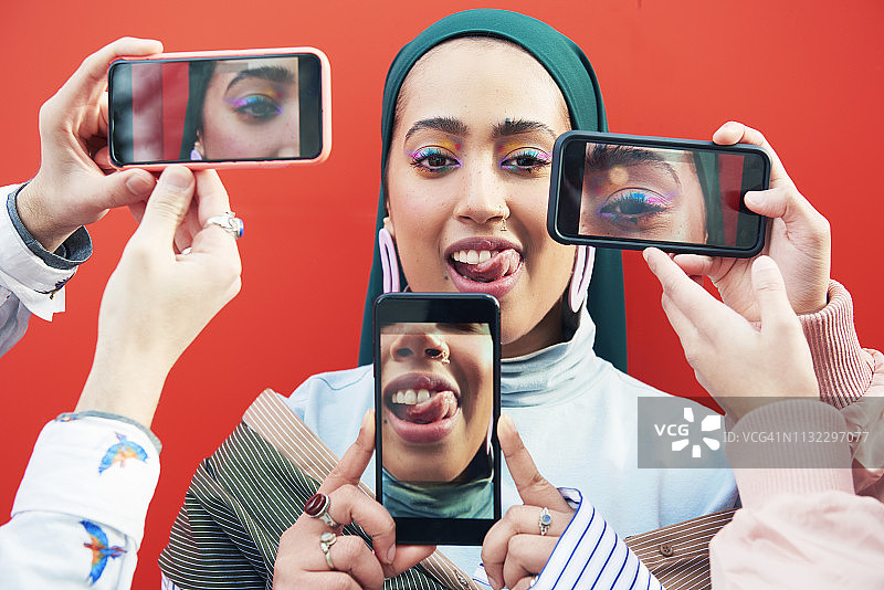 被智能手机包围的年轻女人图片素材