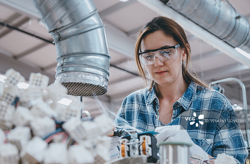 女工在工厂焊接制造设备的电线图片素材