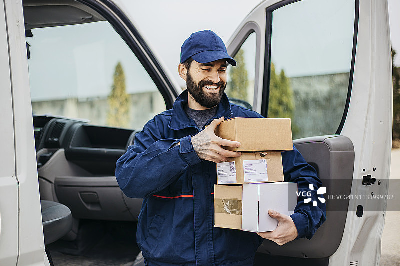 抱着一堆箱子的快递员图片素材
