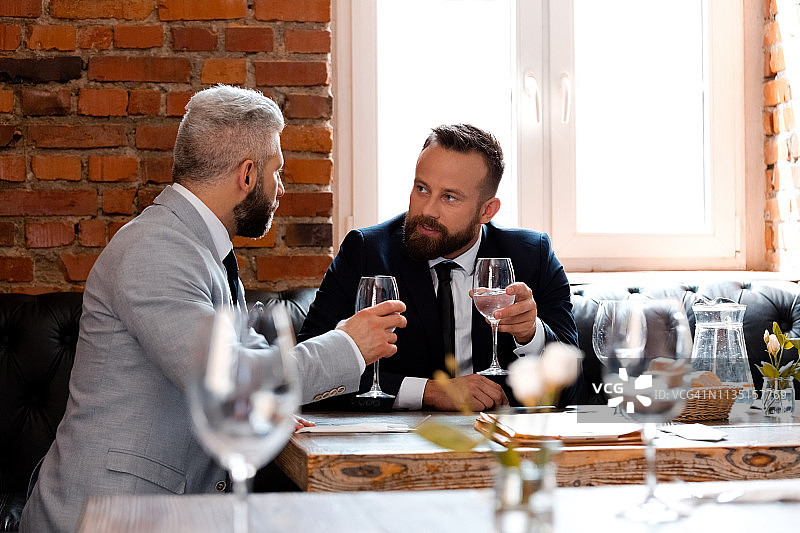 商人在啤酒厂开会时喝葡萄酒图片素材