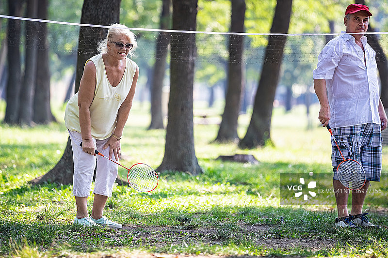 等待发球的老年羽毛球双打选手图片素材
