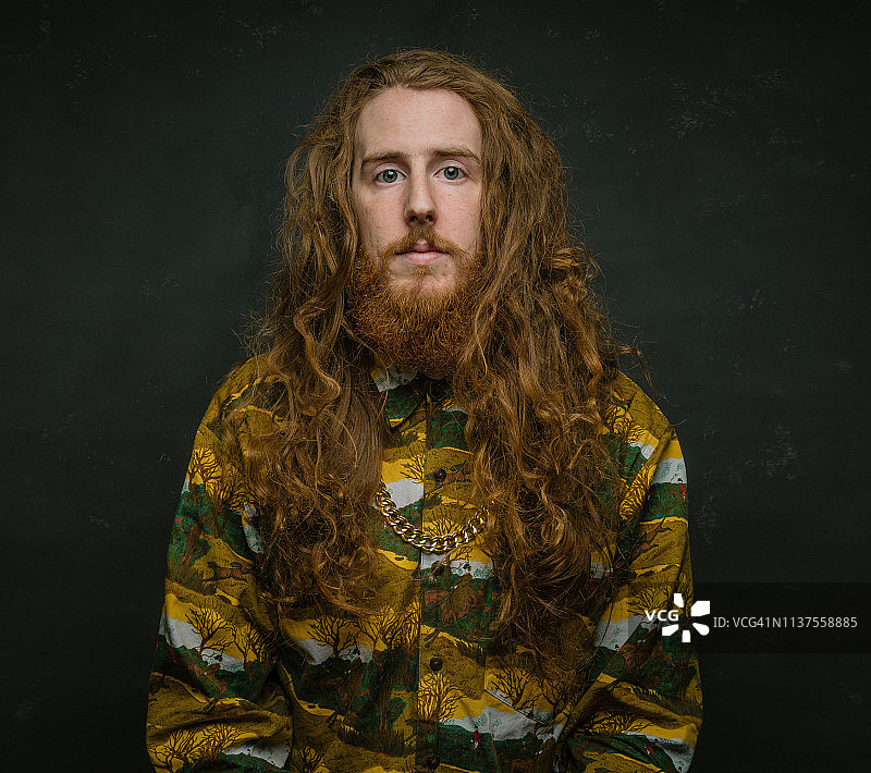 深色背景下的长发络腮胡时尚男人图片素材