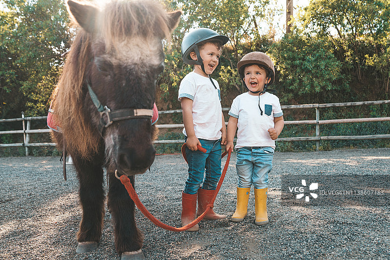 和矮种马一起玩耍的孩子们图片素材