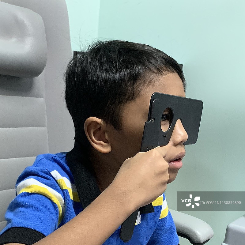 亚洲男孩在验光师处进行视力检查图片素材