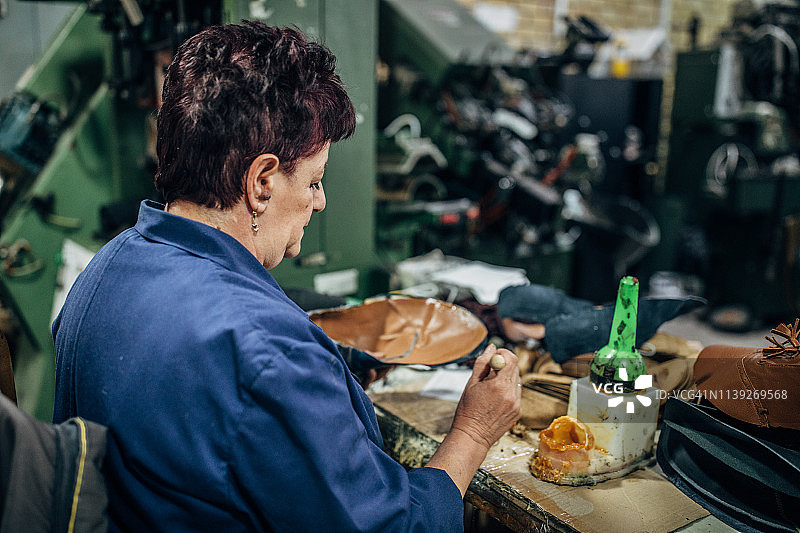 在鞋厂努力工作的中年女士图片素材
