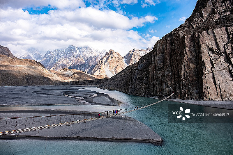 巴基斯坦洪扎吉尔吉特-巴尔蒂斯坦，人们走过侯赛尼吊桥图片素材