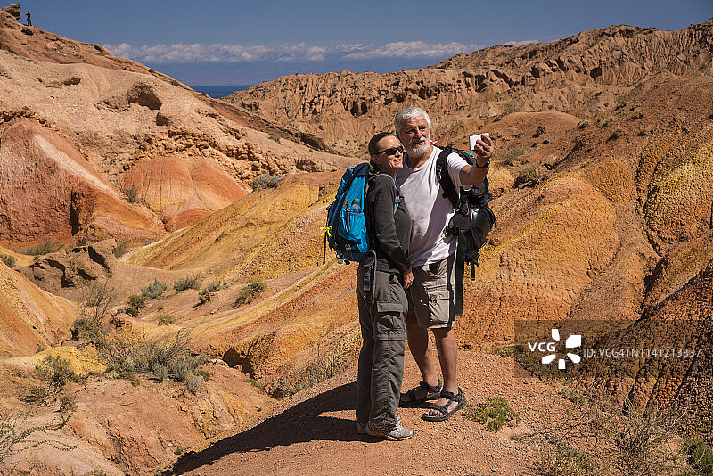 老年人在吉尔吉斯斯坦童话峡谷与伊塞克湖背景下图片素材