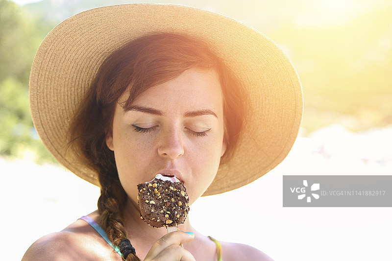 年轻女人吃巧克力冰淇淋图片素材