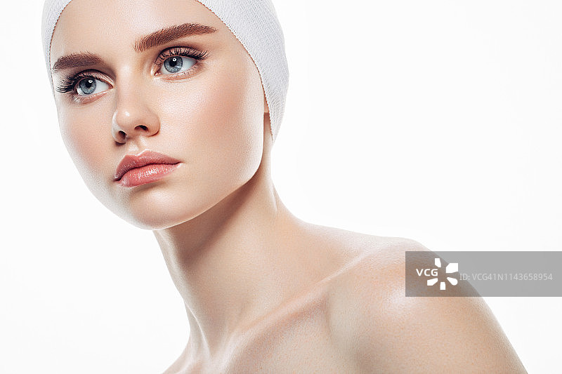 在女人脸上涂抹护肤霜图片素材