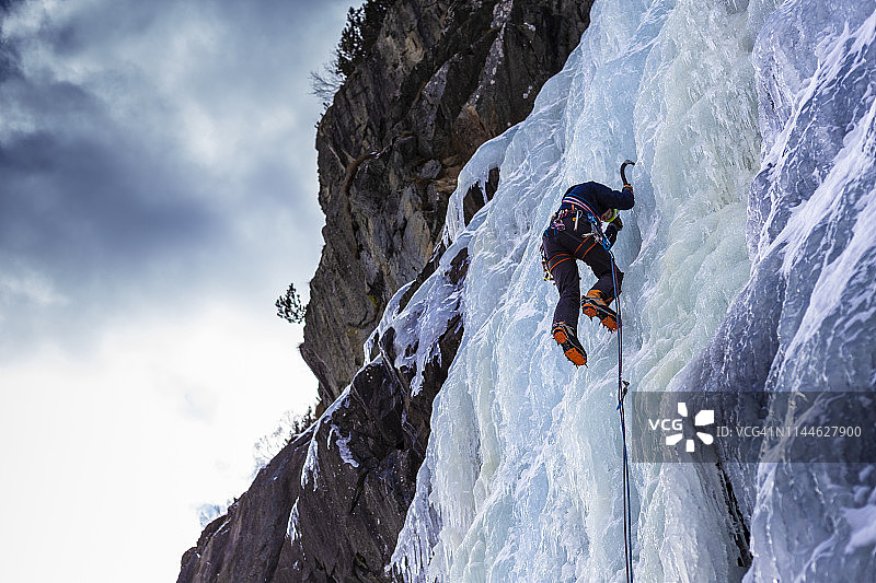 攀岩者攀登冰冻瀑布，意大利伦巴第图片素材