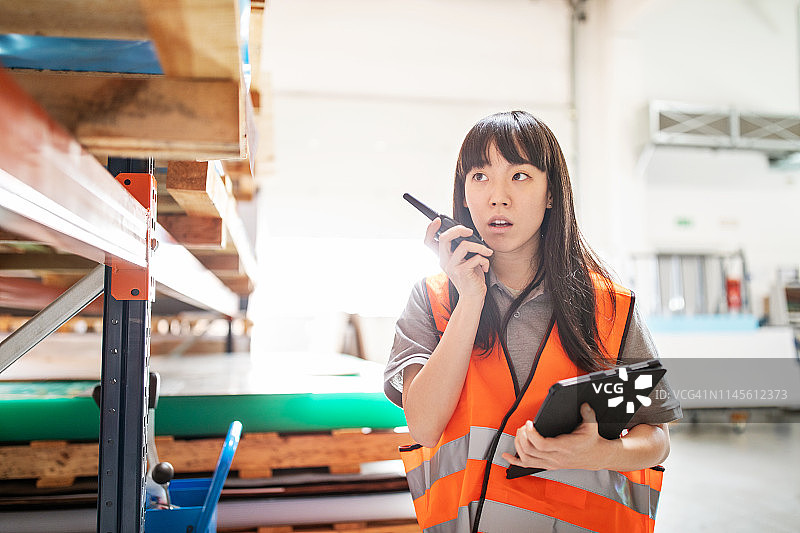 女仓库工人用对讲机汇报图片素材