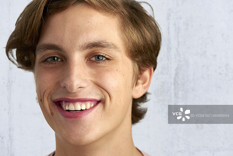 涂着口红的微笑的年轻男人特写图片素材