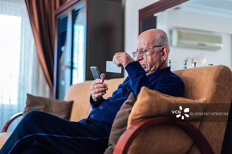 老年男人在家网上购物图片素材