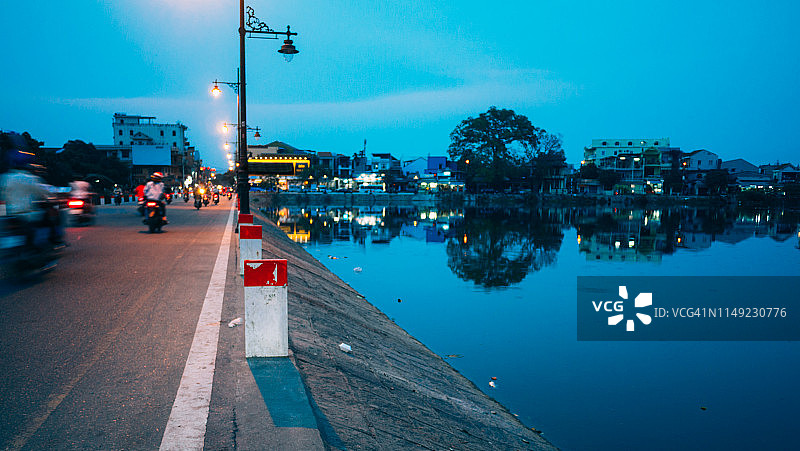 黄昏时分，摩托车行驶在桥上图片素材