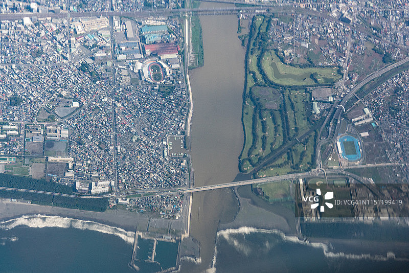 从飞机上看到的日本平冢市、茅崎市和太平洋的白天航拍图图片素材