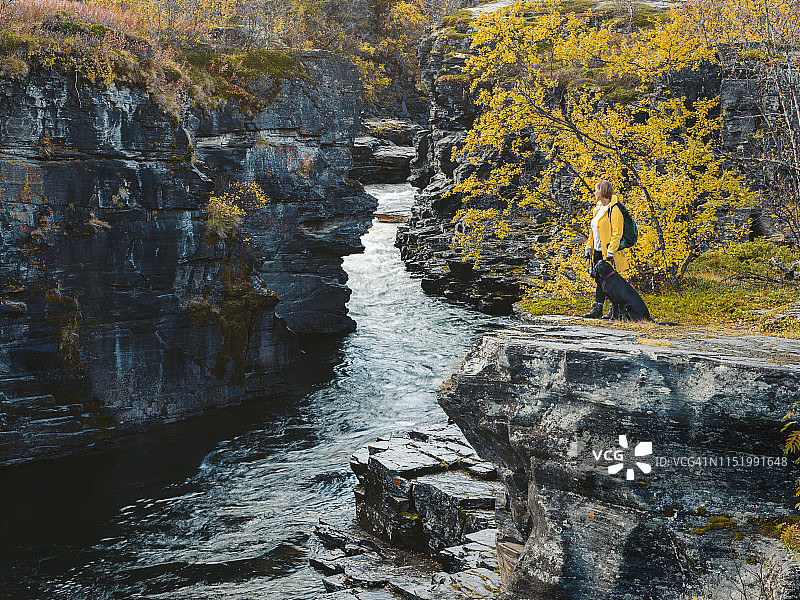 女人和小狗看着河流图片素材