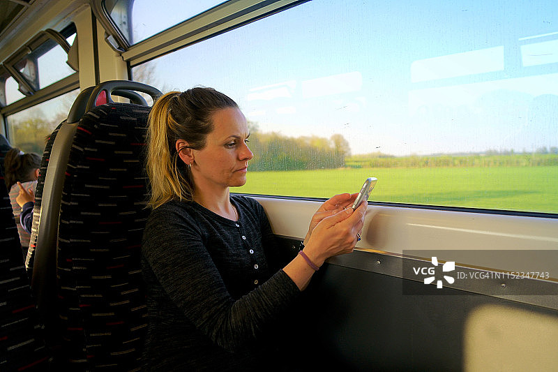 在英国旅行的火车上使用电子阅读器图片素材