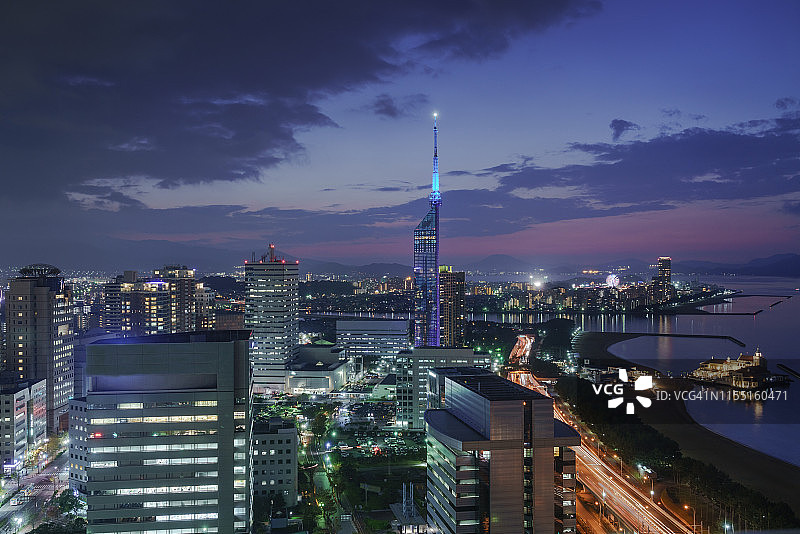 福冈塔全景：无人机在日落时分拍摄的福冈塔航拍图，以及日本福冈县Momochi海滩的景色图片素材