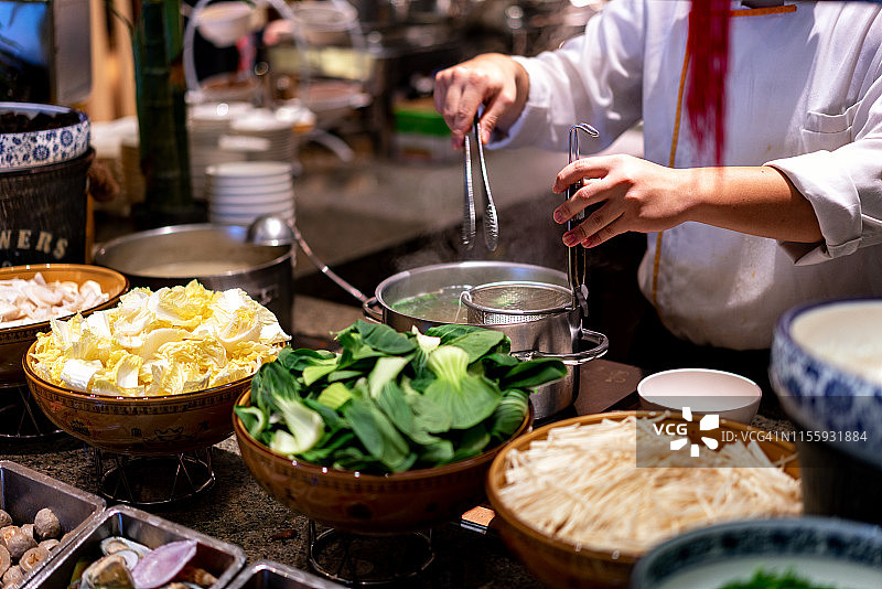 厨师正在煮面条和蔬菜图片素材