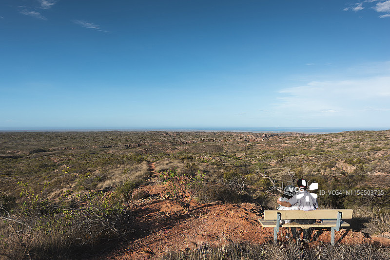 情侣坐在椅子上欣赏海角山脉的景色图片素材