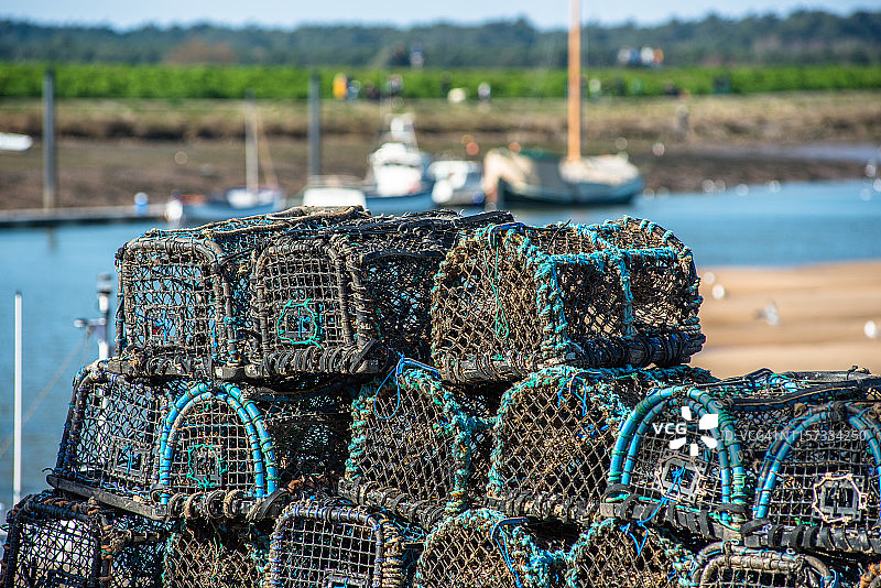堆放在英国东安格利亚诺福克郡韦尔斯海滨的螃蟹和龙虾笼子图片素材