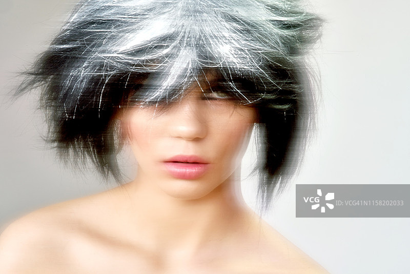 一位画着几何眼线、态度酷酷的年轻女人图片素材