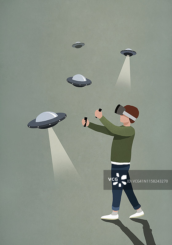男孩戴VR眼镜玩UFO游戏图片素材