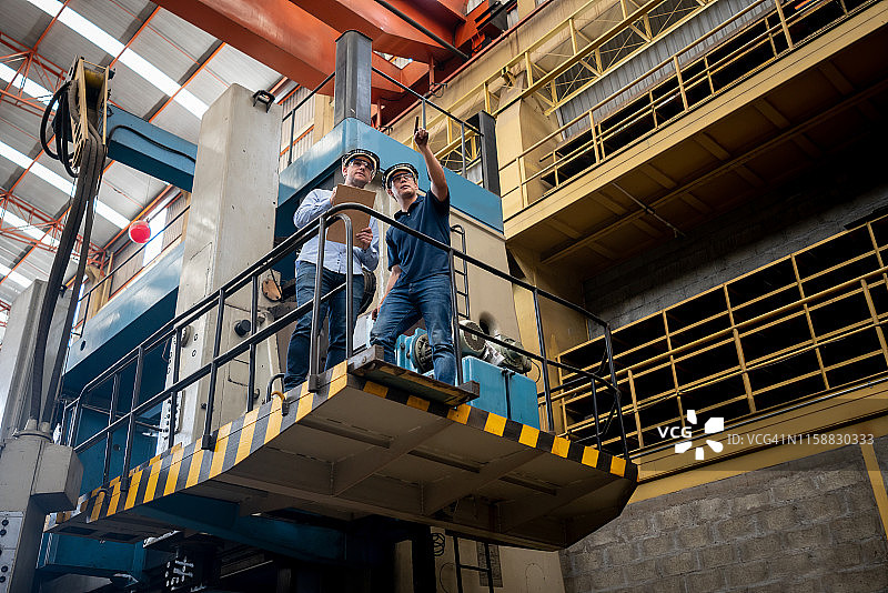 工程师站在叉车上监督工厂的运作图片素材