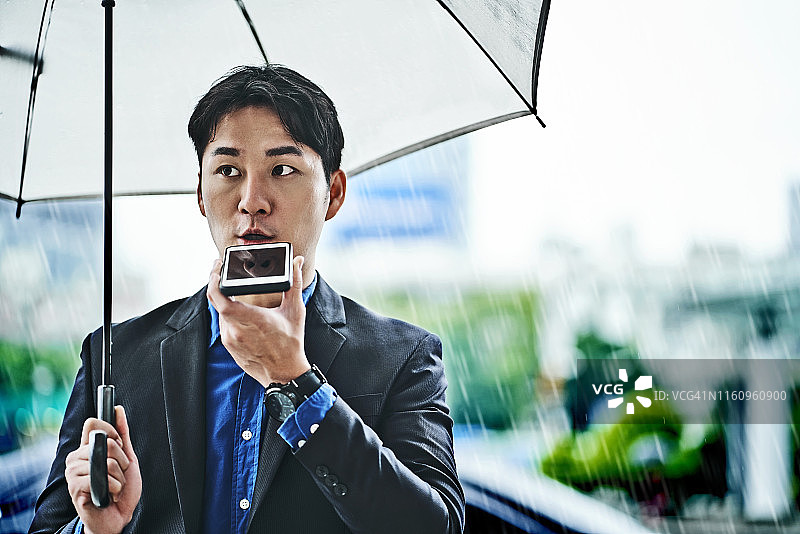 雨中通话的企业家图片素材