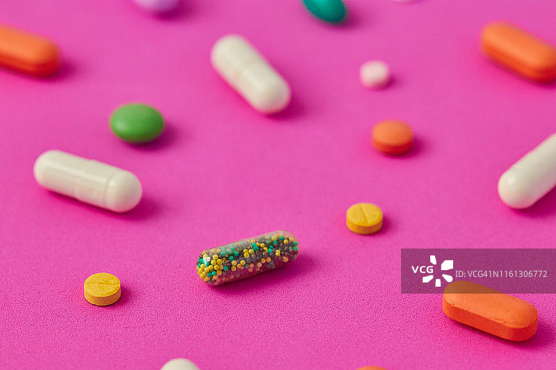 彩色背景上的药丸、胶囊和药片图片素材