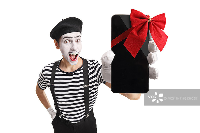 拿着带蝴蝶结手机的哑剧男人图片素材