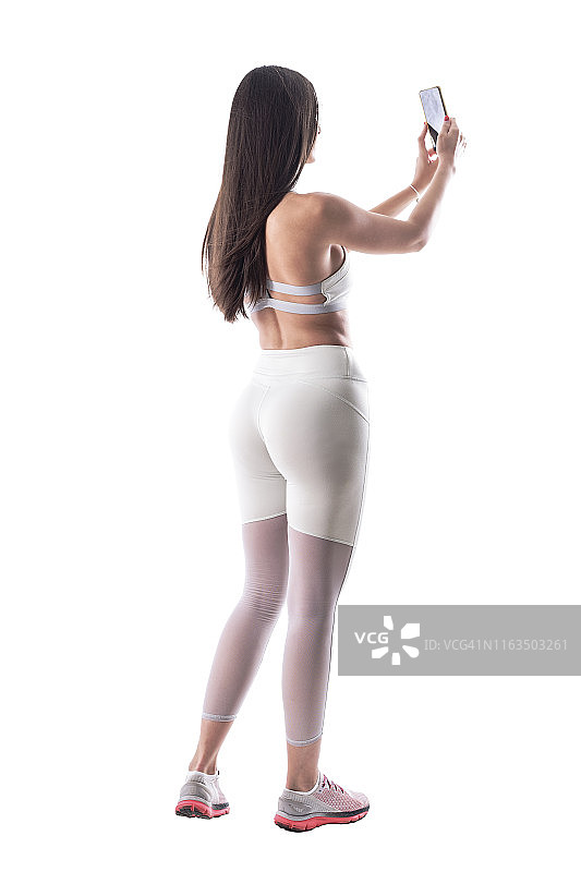 身材健美的时尚女性自拍的背影图片素材