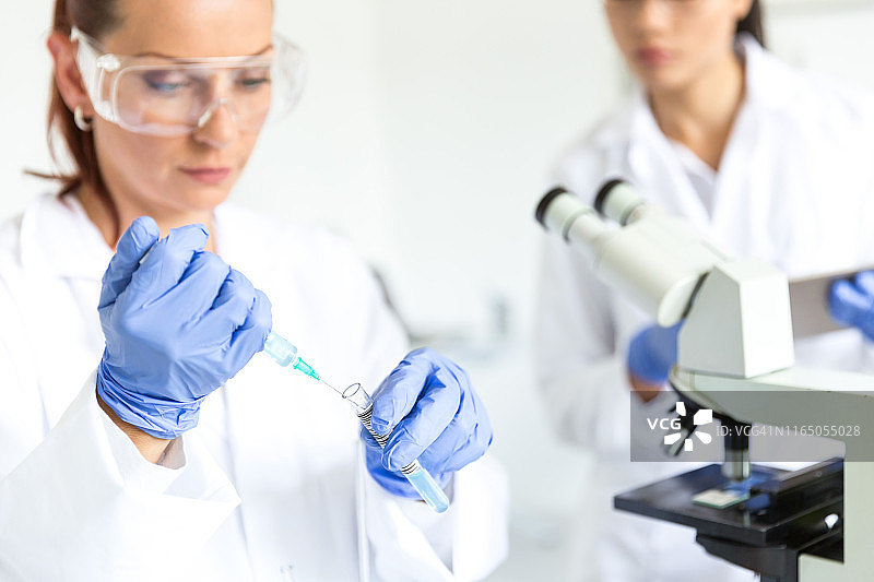 微生物学家用烧瓶进行实验室检查图片素材