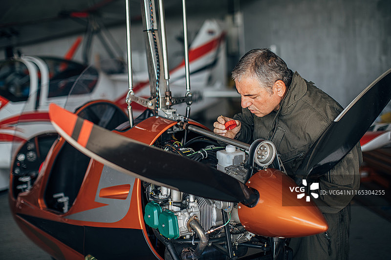 修理螺旋桨飞机的飞机机械师图片素材