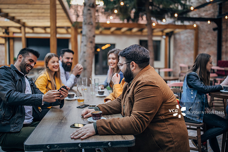朋友们坐在咖啡馆的户外区图片素材
