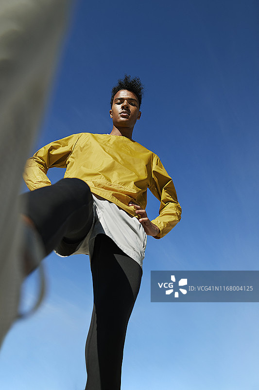 仰视视角下的运动员，背景是晴朗的天空图片素材