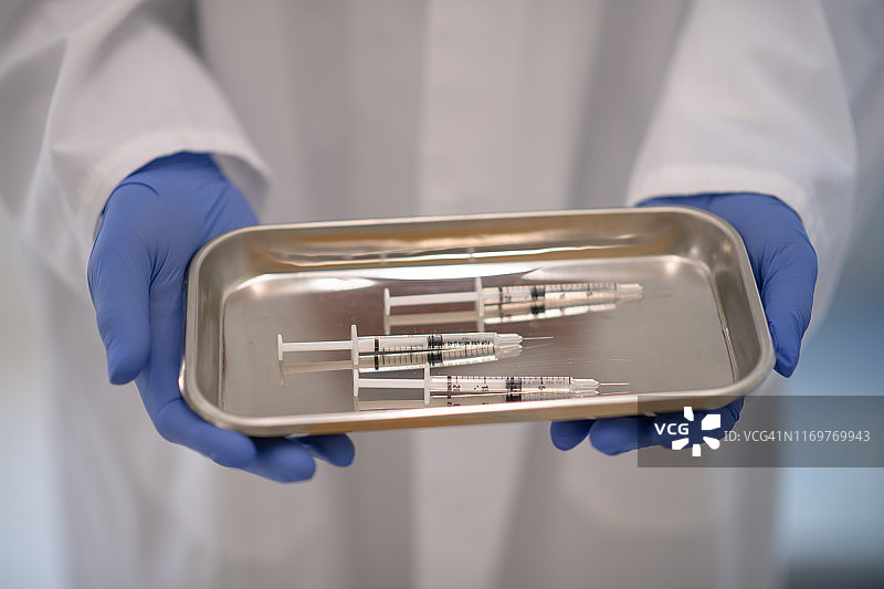 手持流感疫苗注射器的医生图片素材