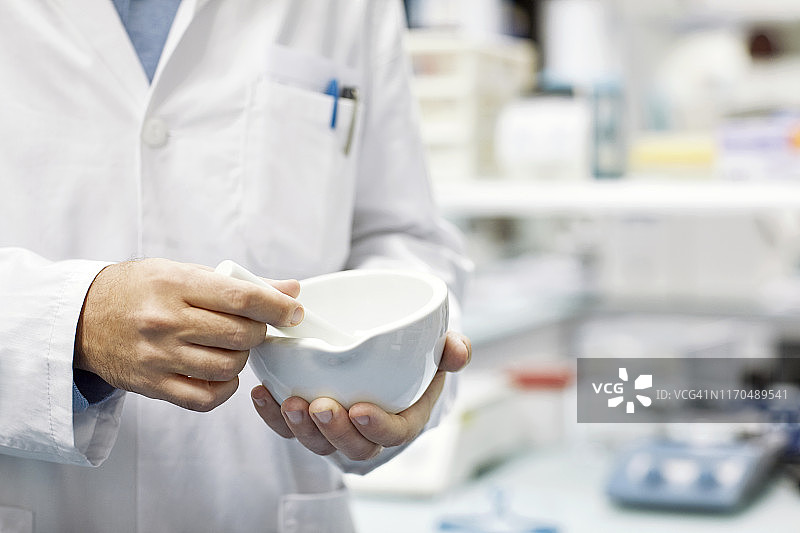 男药剂师配药的腰部特写图片素材