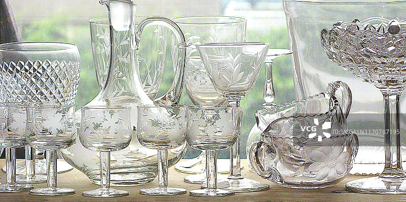 房屋或商店窗台上的古董透明切割水晶玻璃器皿图片素材