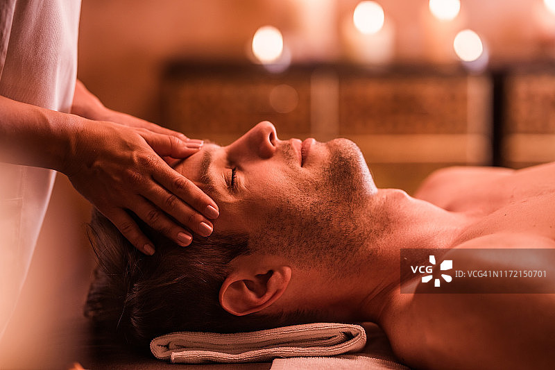 青年男子在水疗中心享受头部按摩图片素材