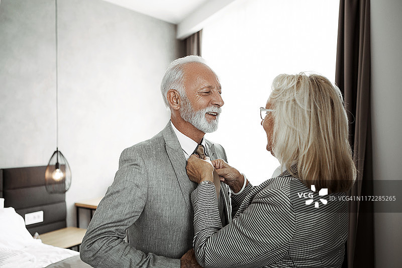 在卧室里和妻子一起打扮的商人图片素材